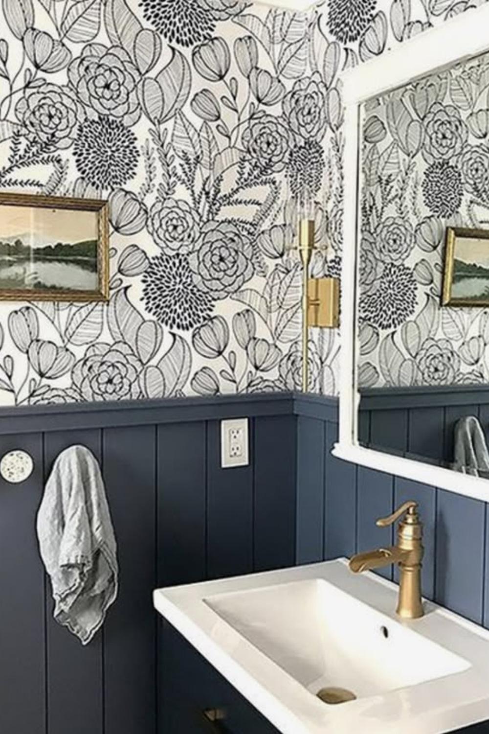 Stylish bathroom featuring floral wallpaper and dark blue shiplap tone