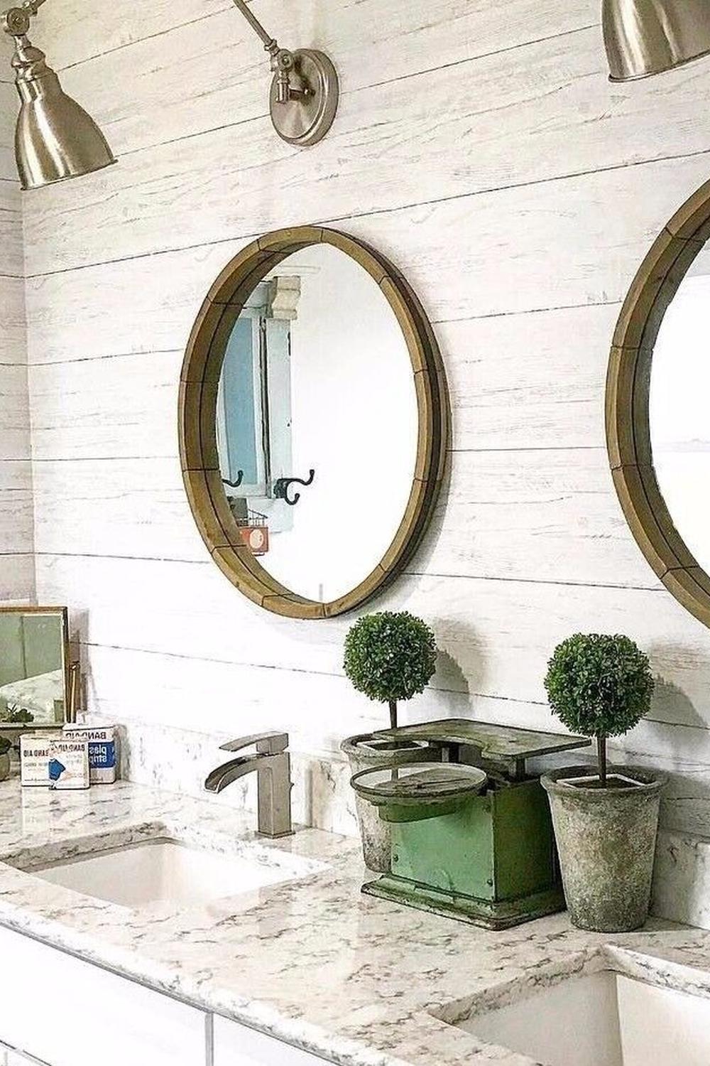 Contemporary bathroom featuring dual round mirrors and shiplap wall treatment