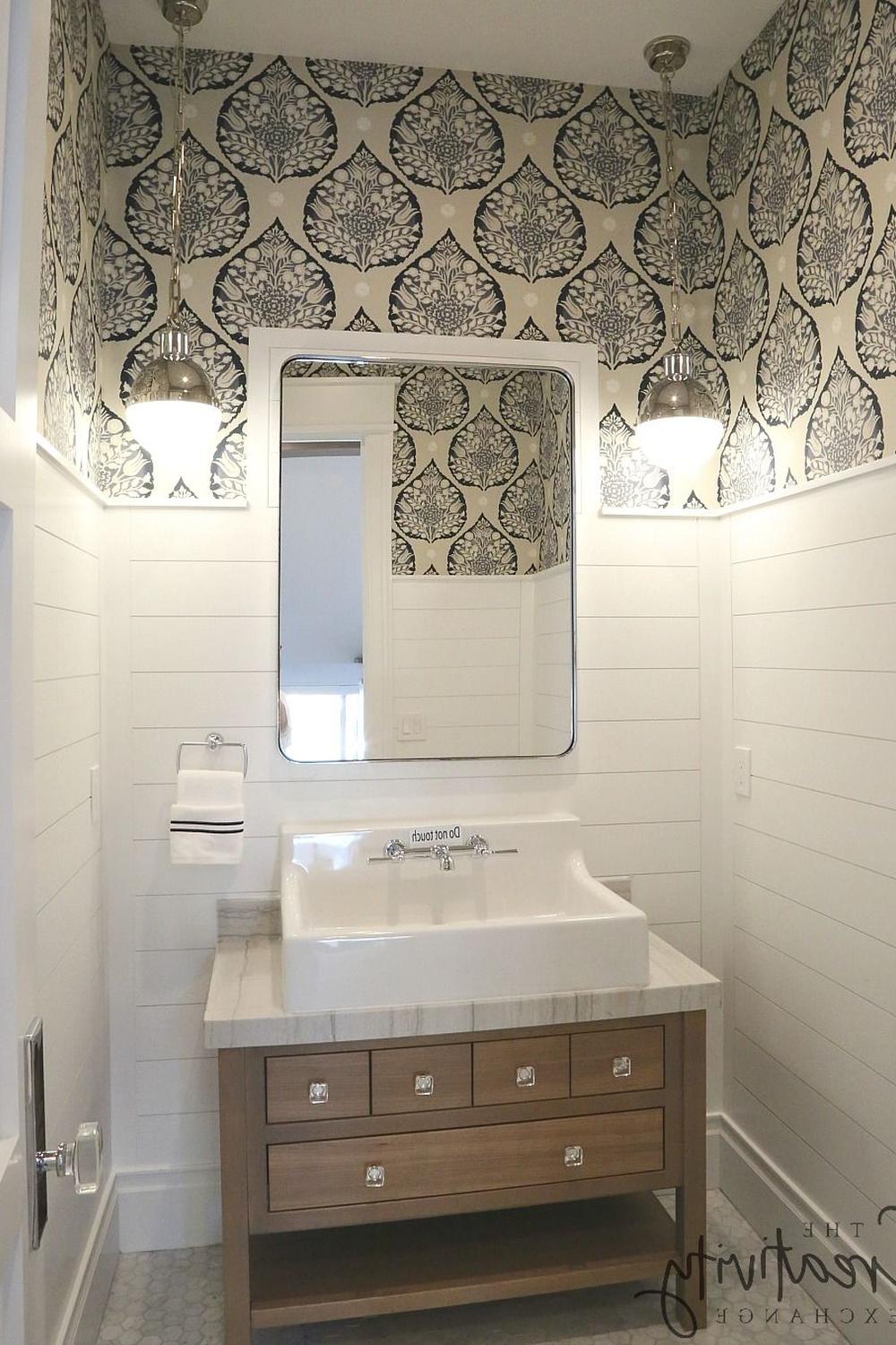 Chic bathroom featuring striking floral wallpaper and practical storage