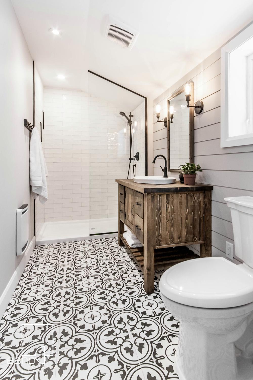 Modern bathroom with soft gray shiplap wall and rustic wooden vanity