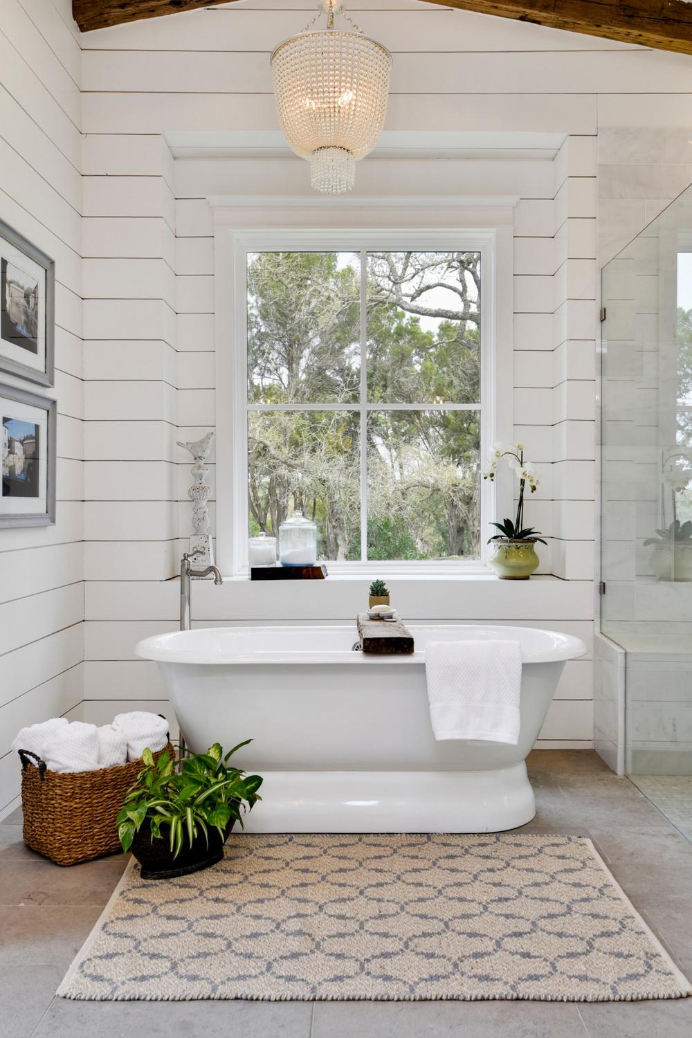 Stylish bathroom featuring a freestanding soaking tub and shiplap walls