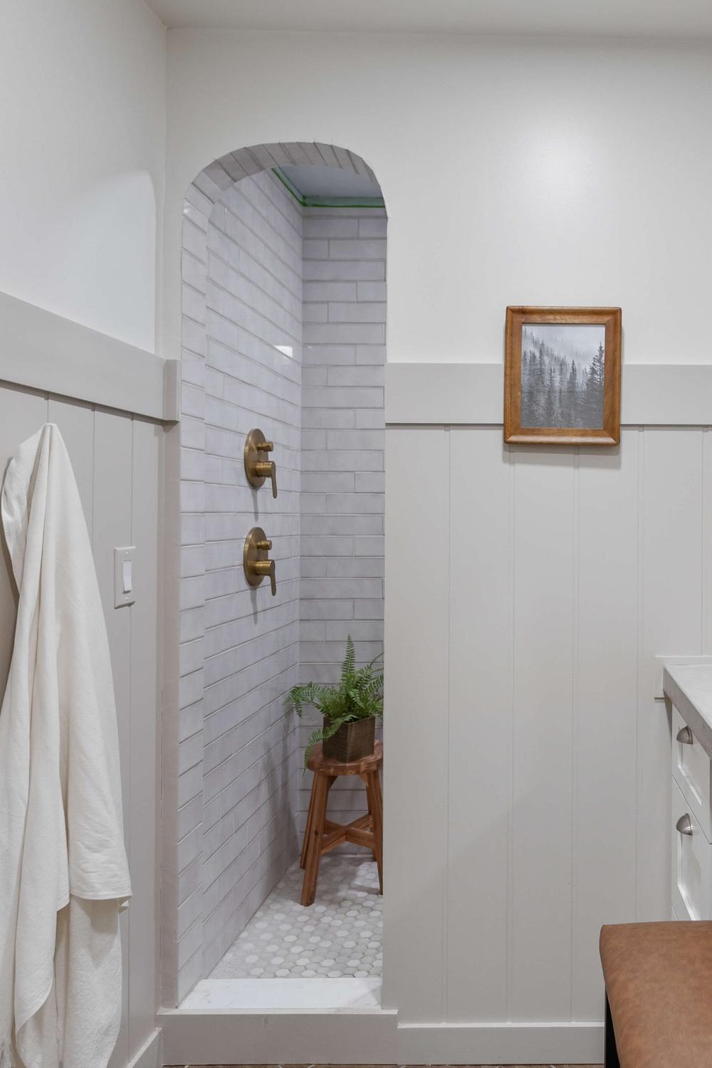 Stylish gray shiplap bathroom with industrial accents and a modern shower