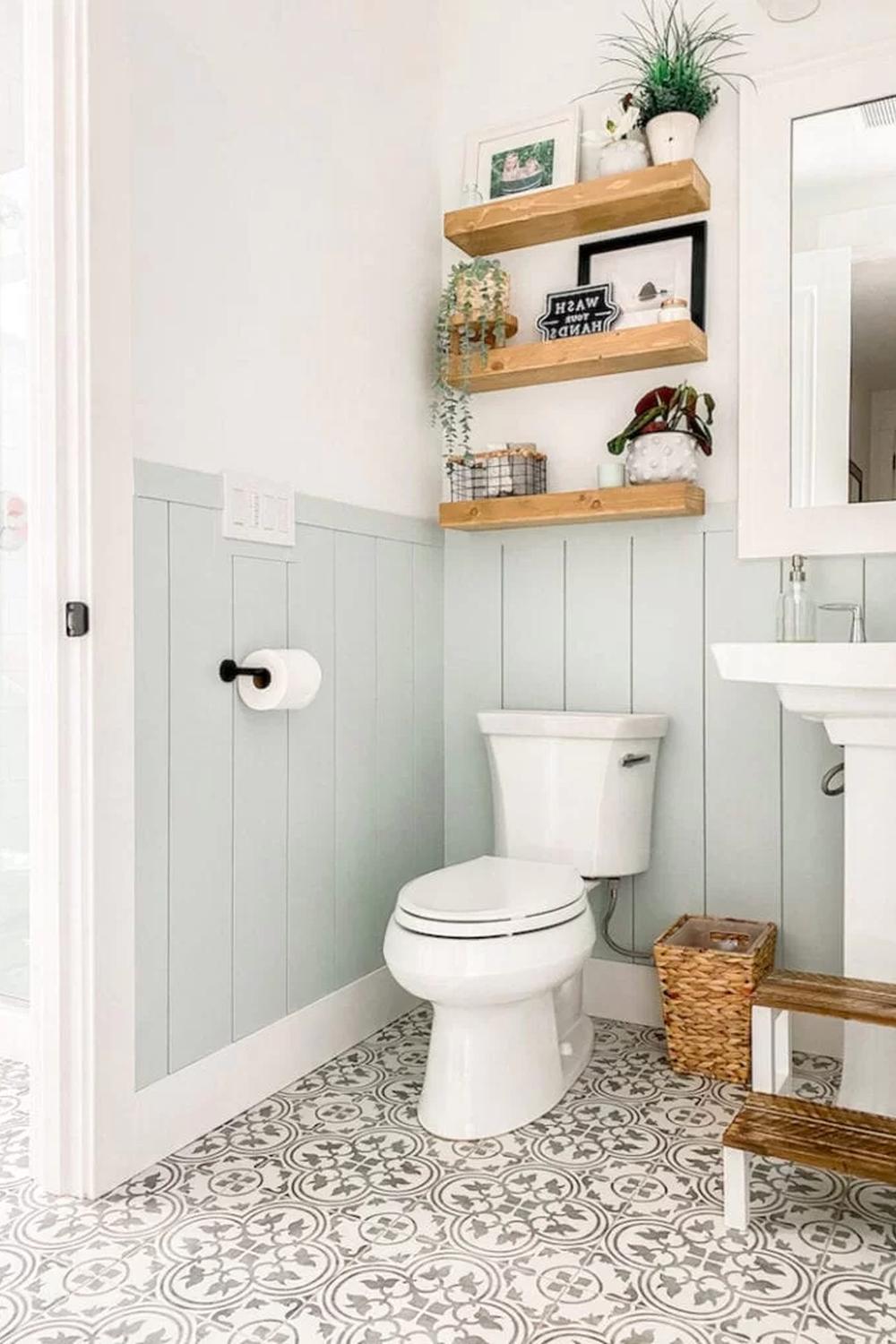 Cozy bathroom design featuring light blue shiplap walls and elegant decor