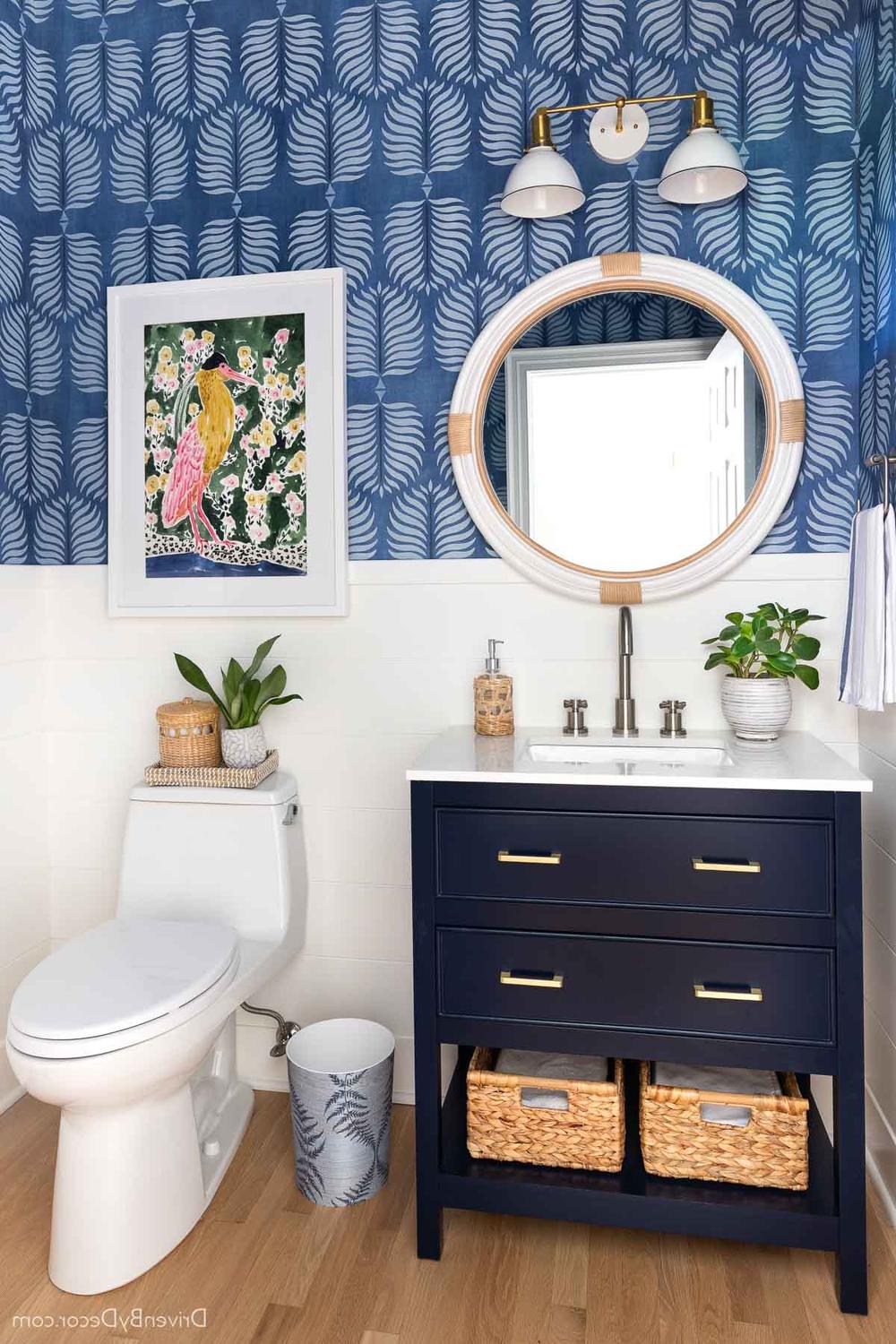 Bright bathroom featuring playful wallpaper and elegant shiplap details