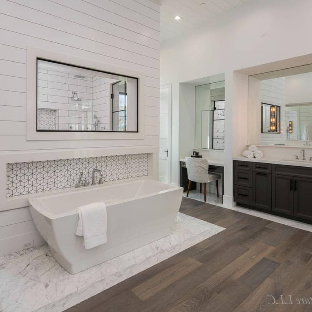 Elegant bathroom showcasing white shiplap, a freestanding bathtub, and marble accents.