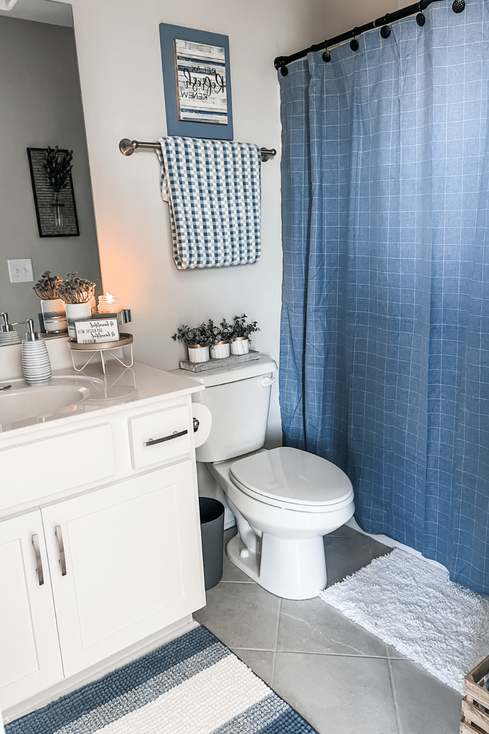 Cozy small bathroom with light blue accents and charming decor