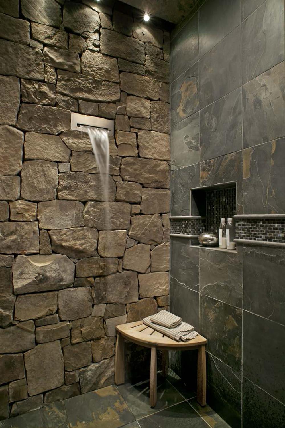 Stylish bathroom shower area featuring slate tiles and a natural aesthetic