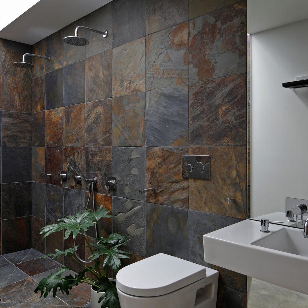 Modern bathroom design with slate-tiled walls and rich color variations