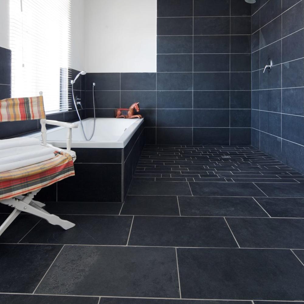 Modern bathroom featuring slate tile flooring and a freestanding bathtub