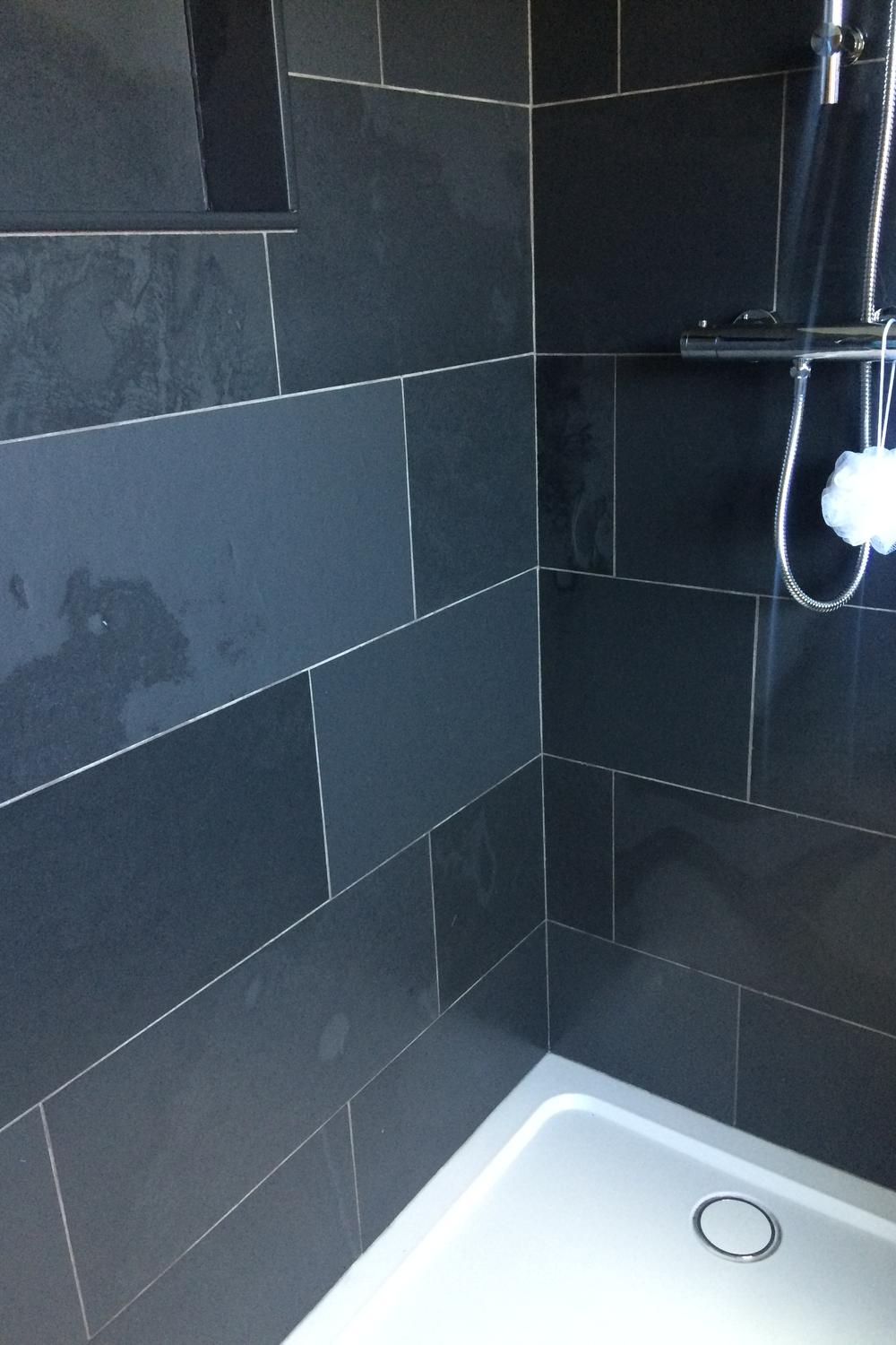 Chic modern shower space with slate tile and contemporary fixtures