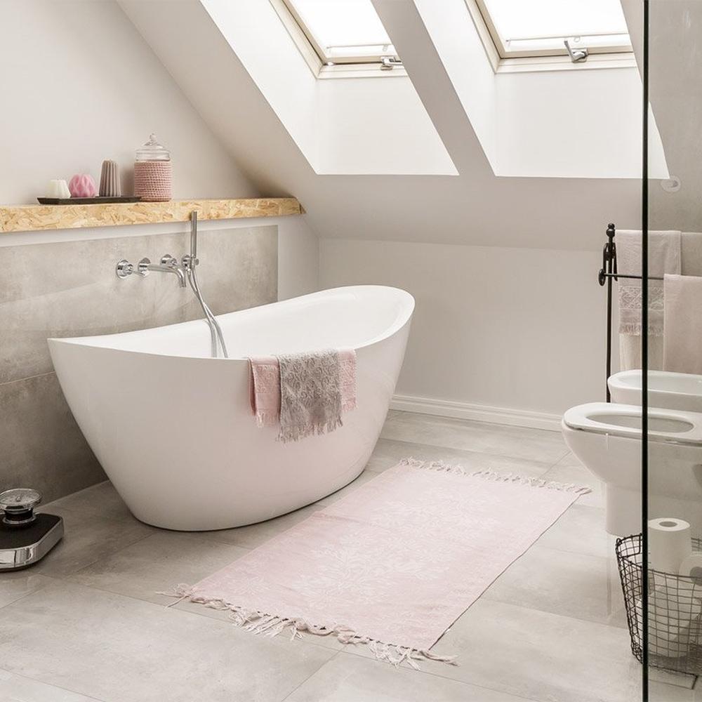 Modern bathroom featuring freestanding tub and natural wood accents