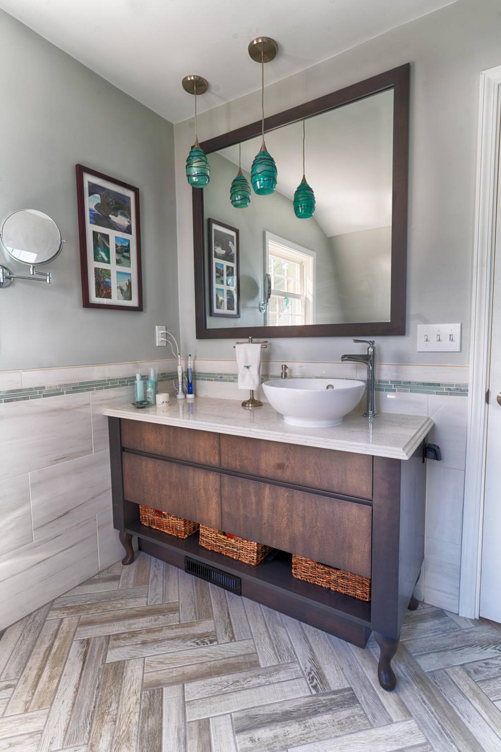 Beautifully designed bathroom featuring dark wood vanity and turquoise accents