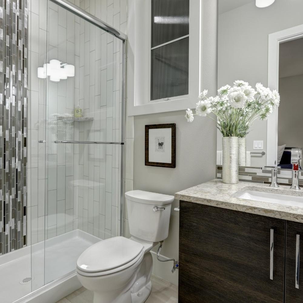 Bright small bathroom with contemporary fixtures and mosaic tiles