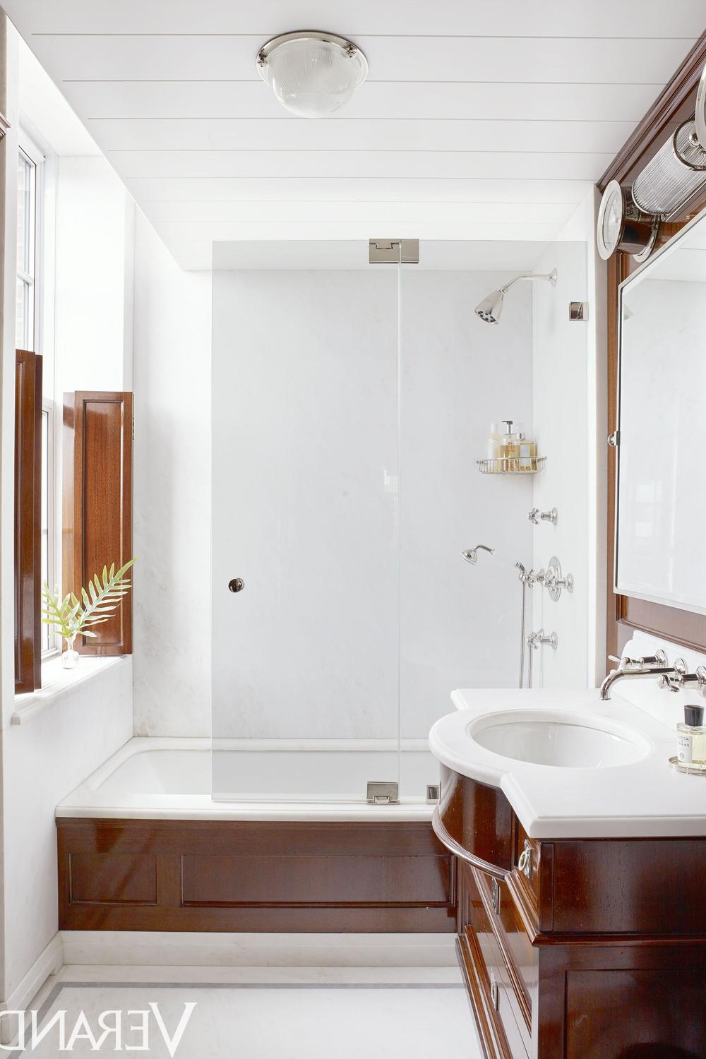 Compact bathroom featuring a clean design with a modern bathtub, sufficient storage solutions, and calming colors.