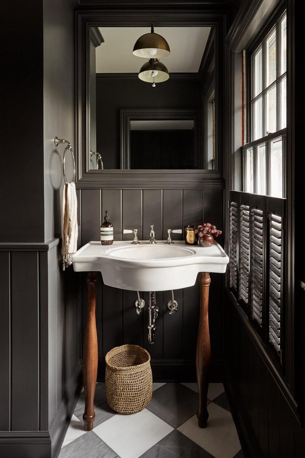 Dark bathroom with natural elements and warm lighting.