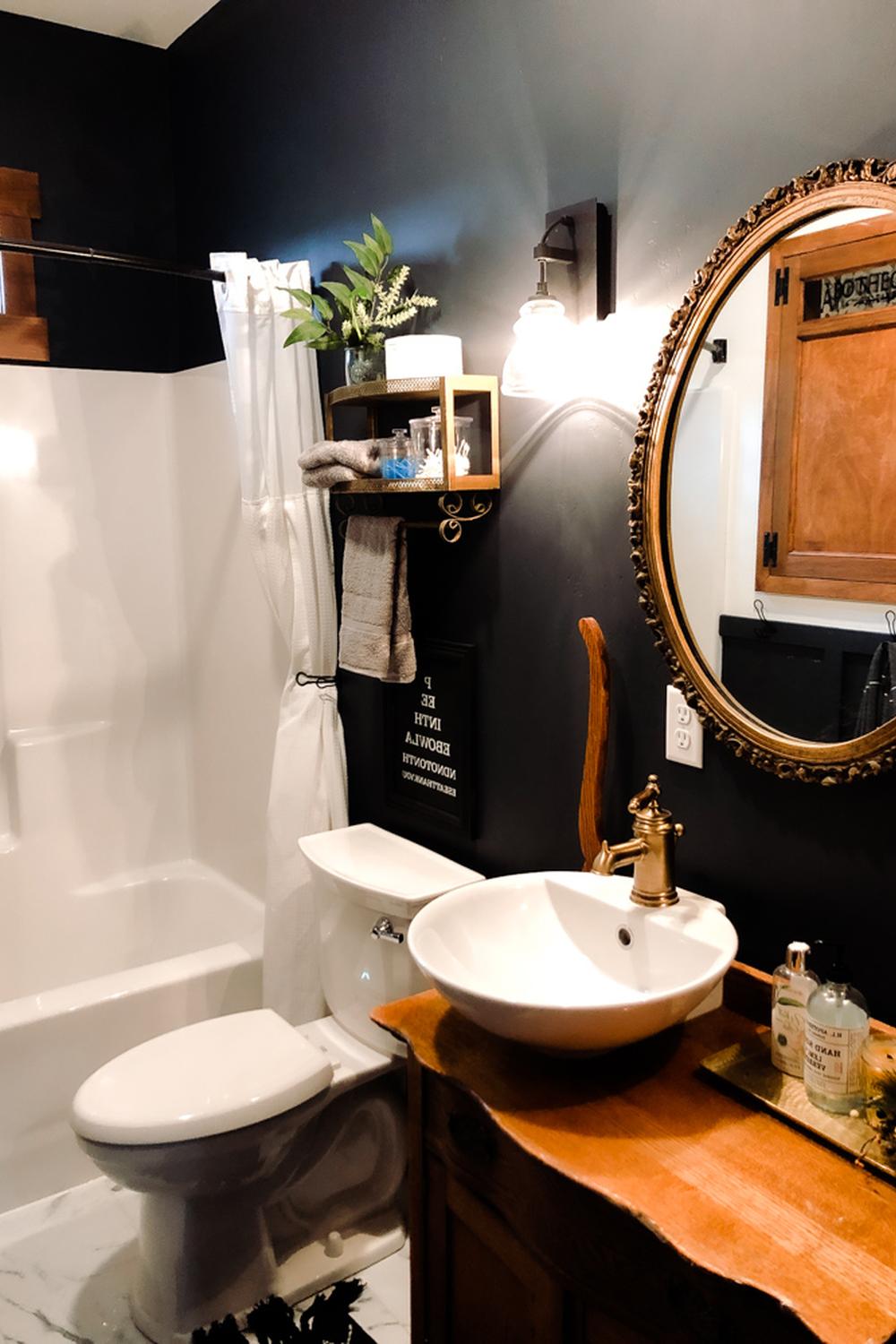 Charming bathroom with a dramatic color palette and creative design.