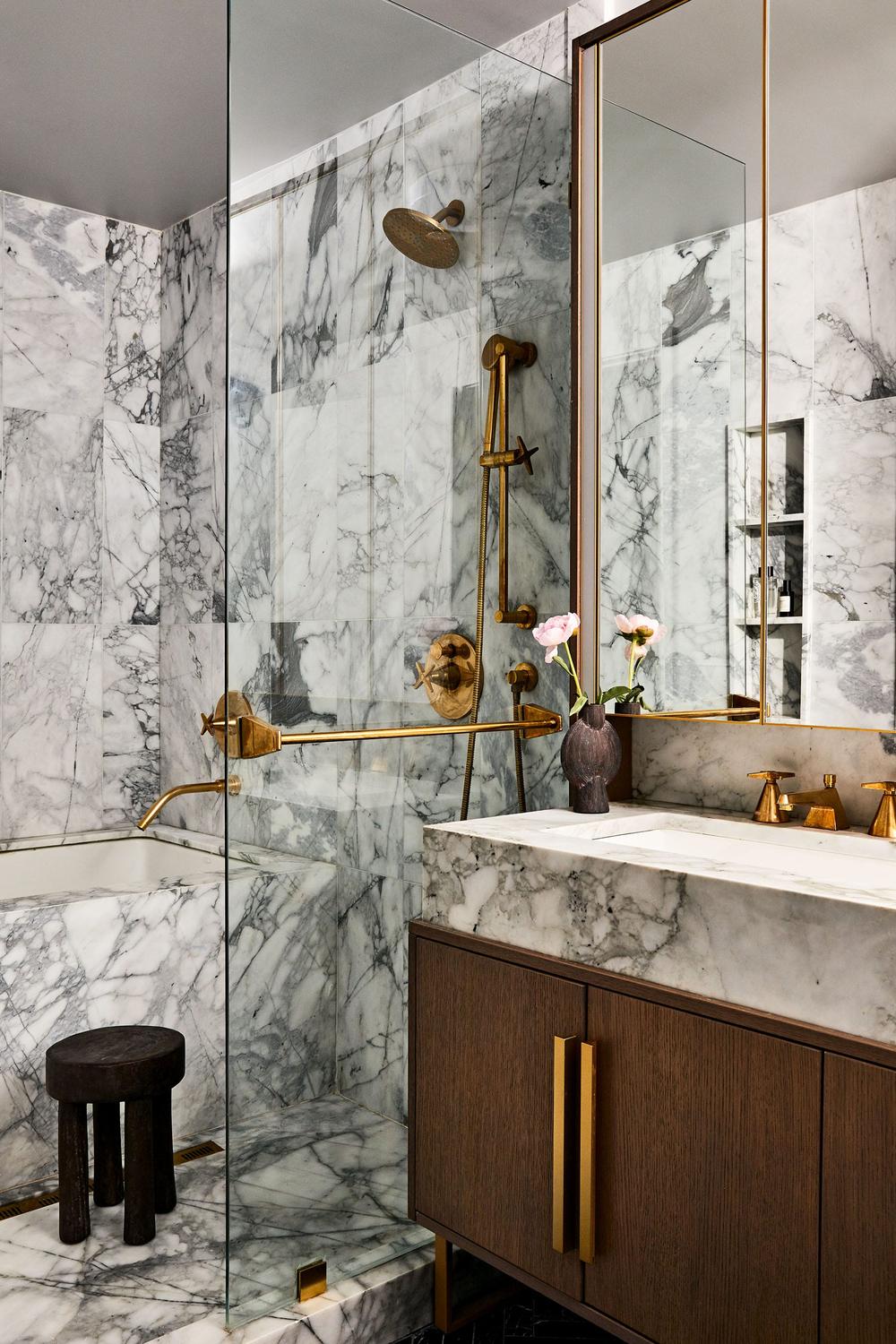 A small luxurious bathroom featuring marble details