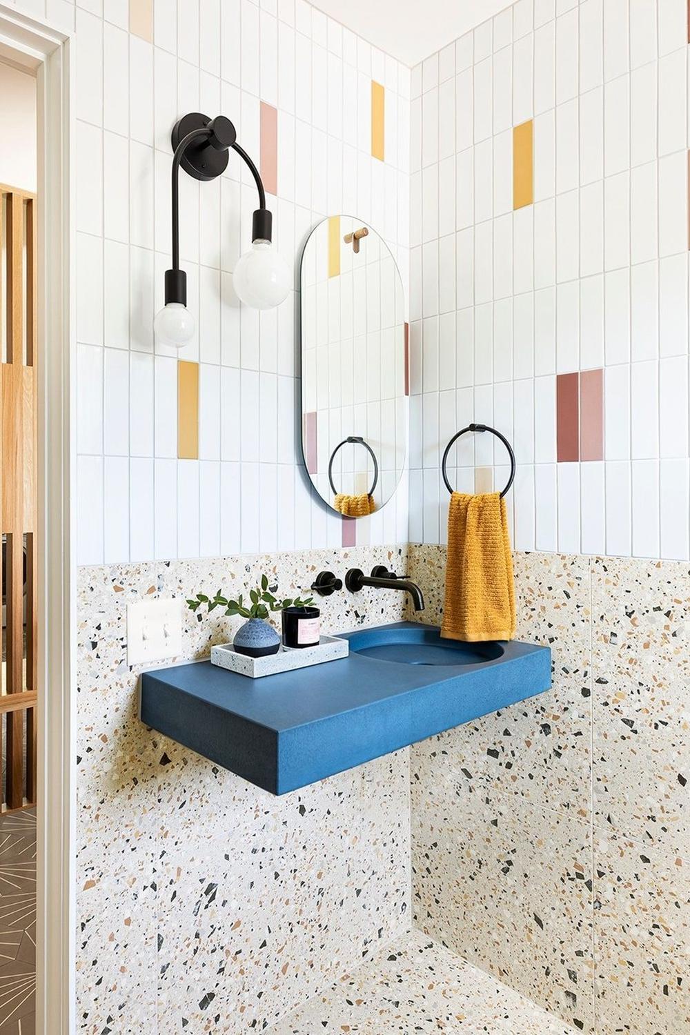 A stylish bathroom with pastel accents and unique tile designs creating a beautiful aesthetic.