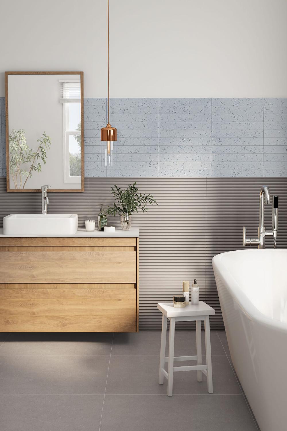 A modern bathroom design with soft blue tiles, wooden elements, and stylish fixtures.