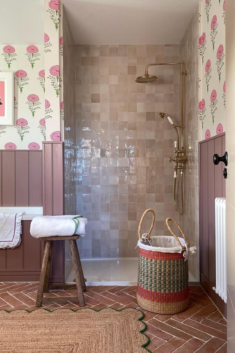 An inviting bathroom filled with glossy pastel tiles and floral accents for a cozy feel.