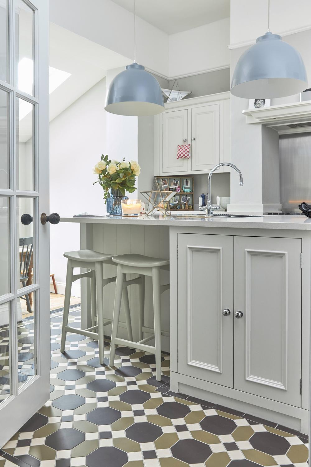 A stylish kitchen incorporating soft pastel tones and elegant tile designs.