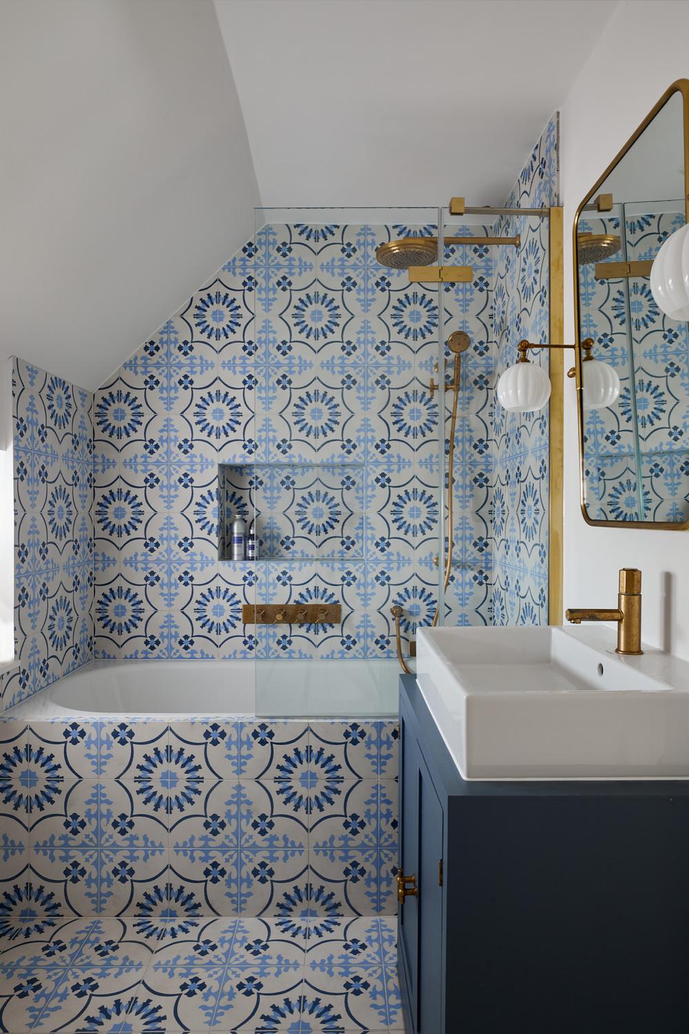 Serene bathroom with blue and white Spanish tiles and modern fixtures