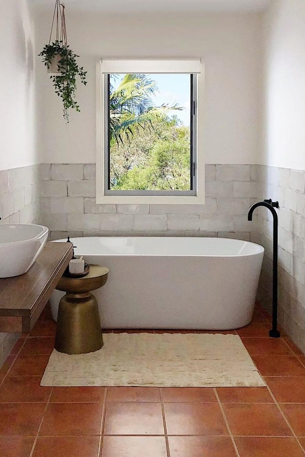 Minimalist bathroom with textured walls and bathtub