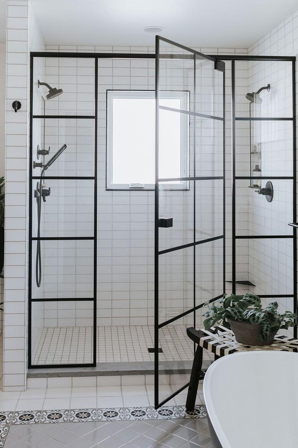 A chic open shower bathroom design featuring modern subway tiles and textured accents.