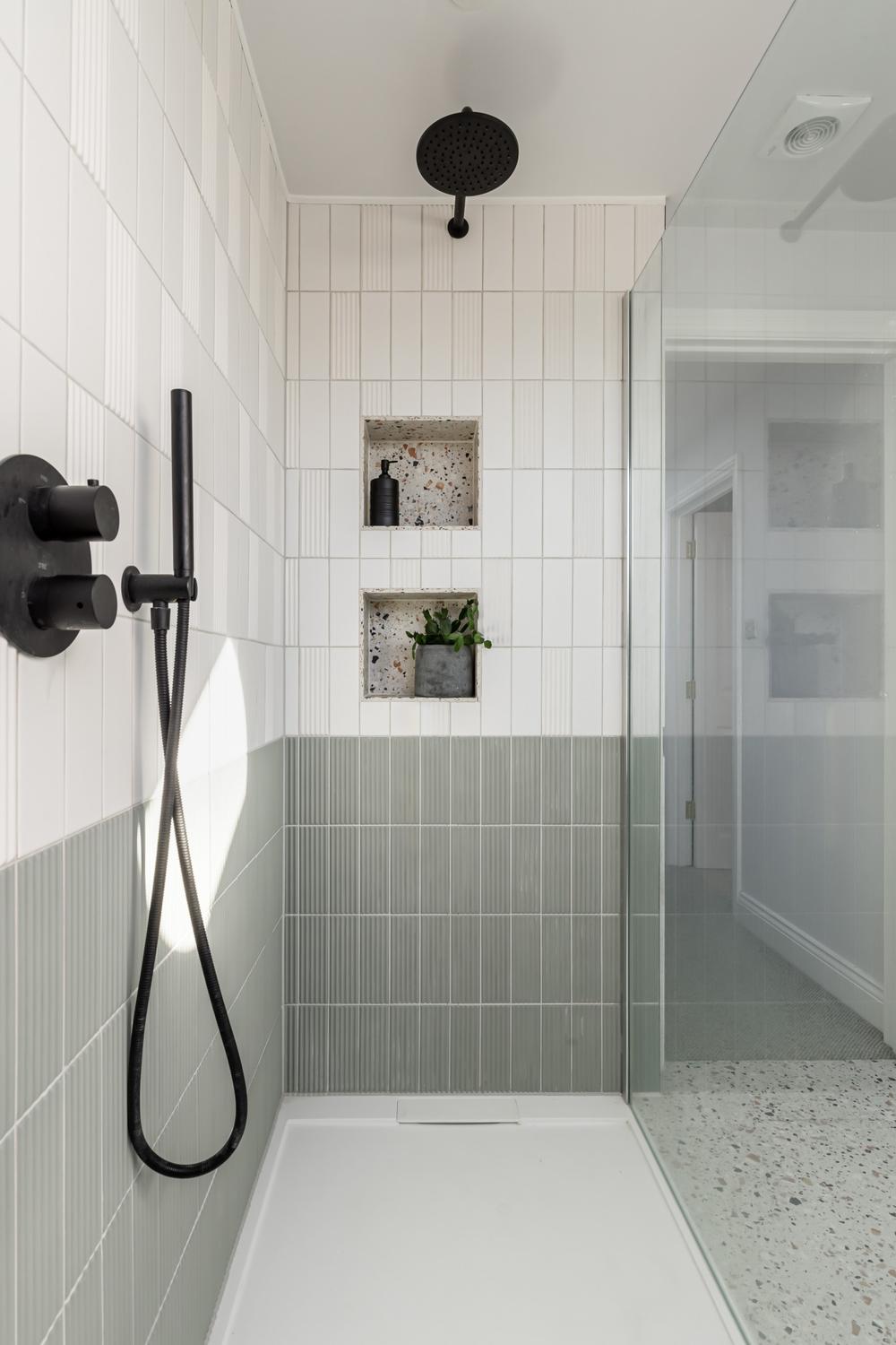 A textured elegant bathroom featuring subway tiles and creative design elements.