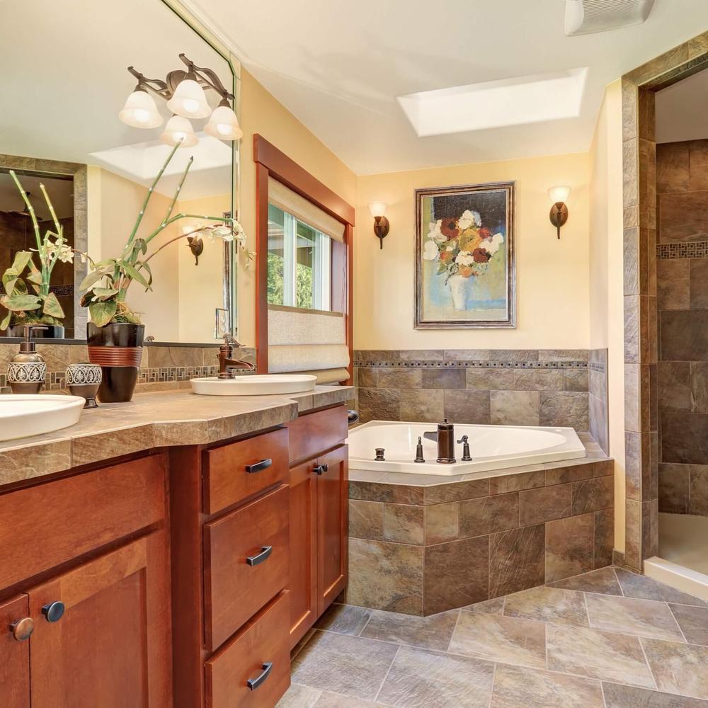 Chic bathroom featuring a blend of stone elements and warm wooden accents.