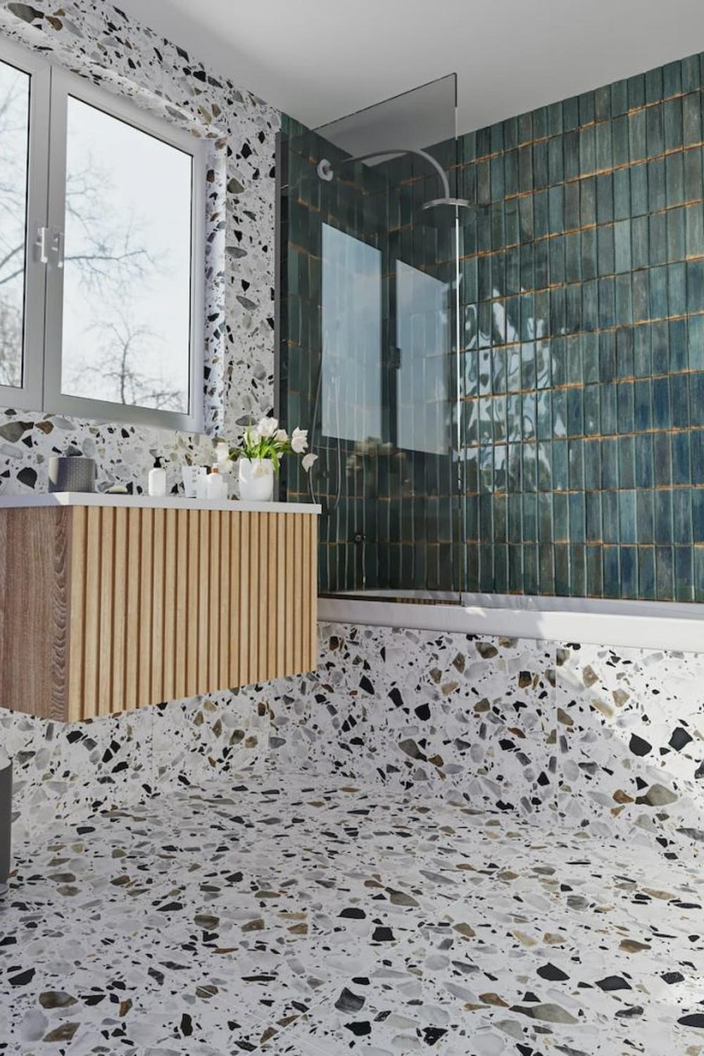 Modern bathroom design featuring light-colored terrazzo flooring and wooden vanity.