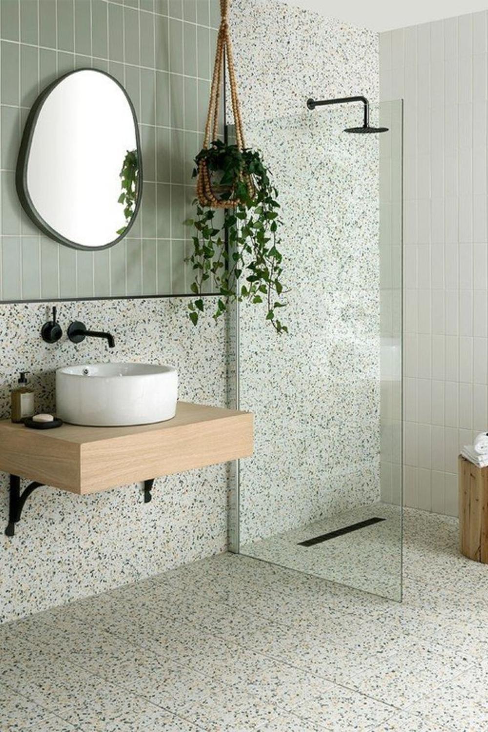 Modern bathroom with chic terrazzo vanity and floating design elements.