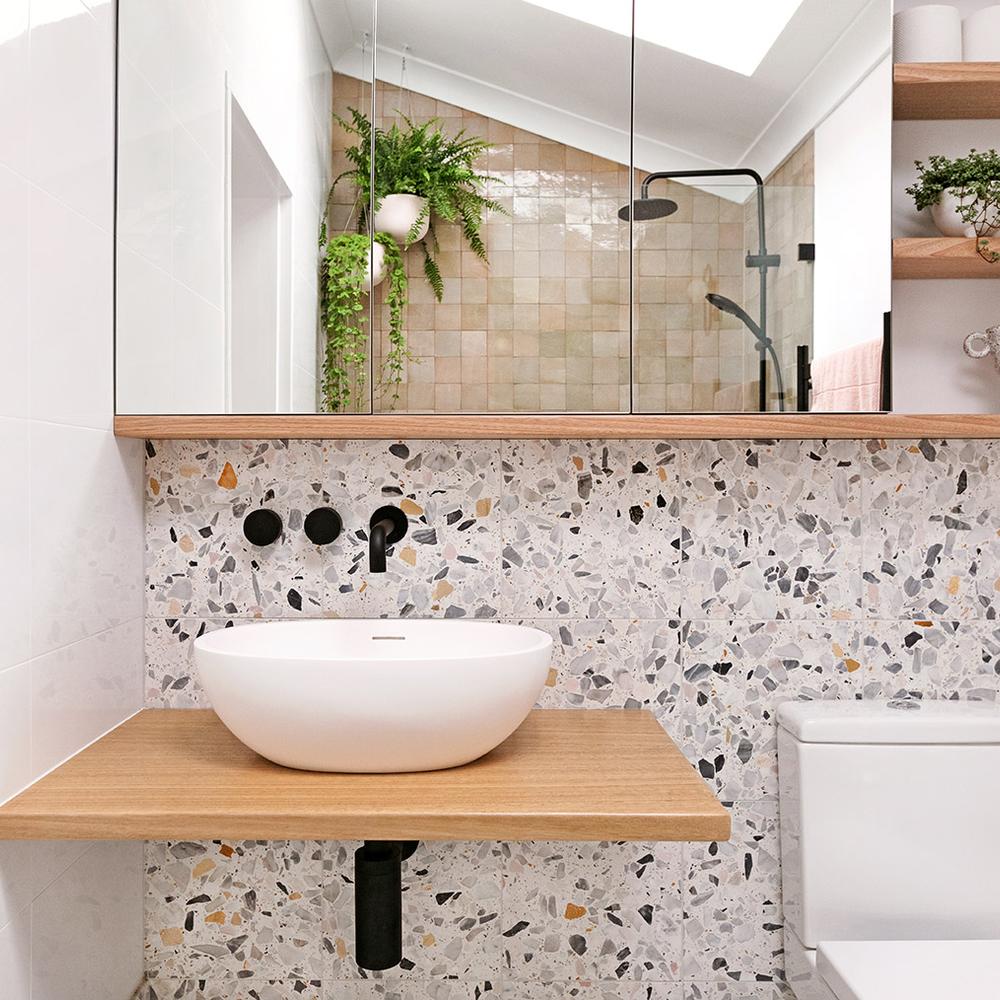 Beautifully designed bathroom with terrazzo vanity and natural accents.