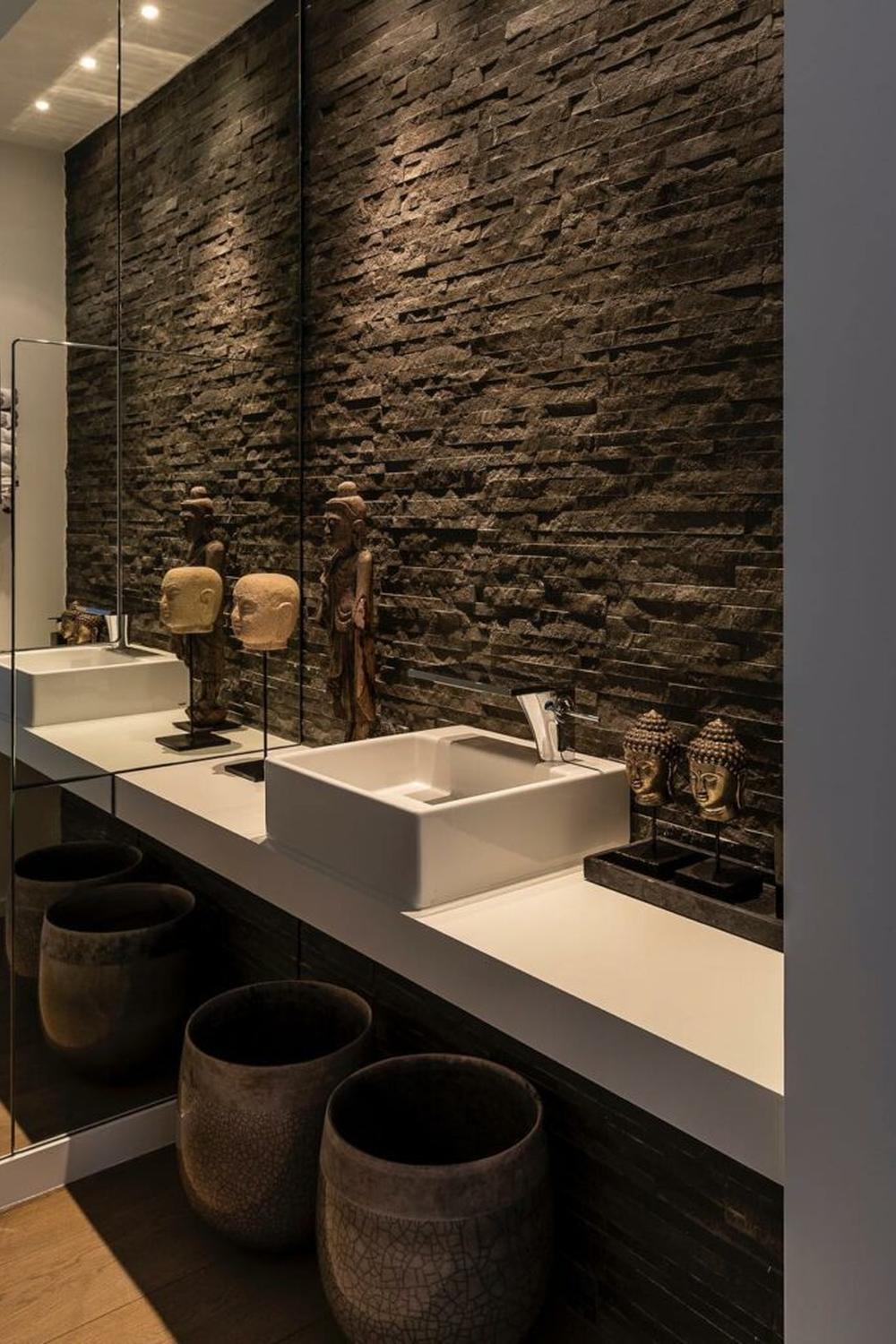 Baño con pared de azulejos negros texturizados que crea un ambiente sofisticado