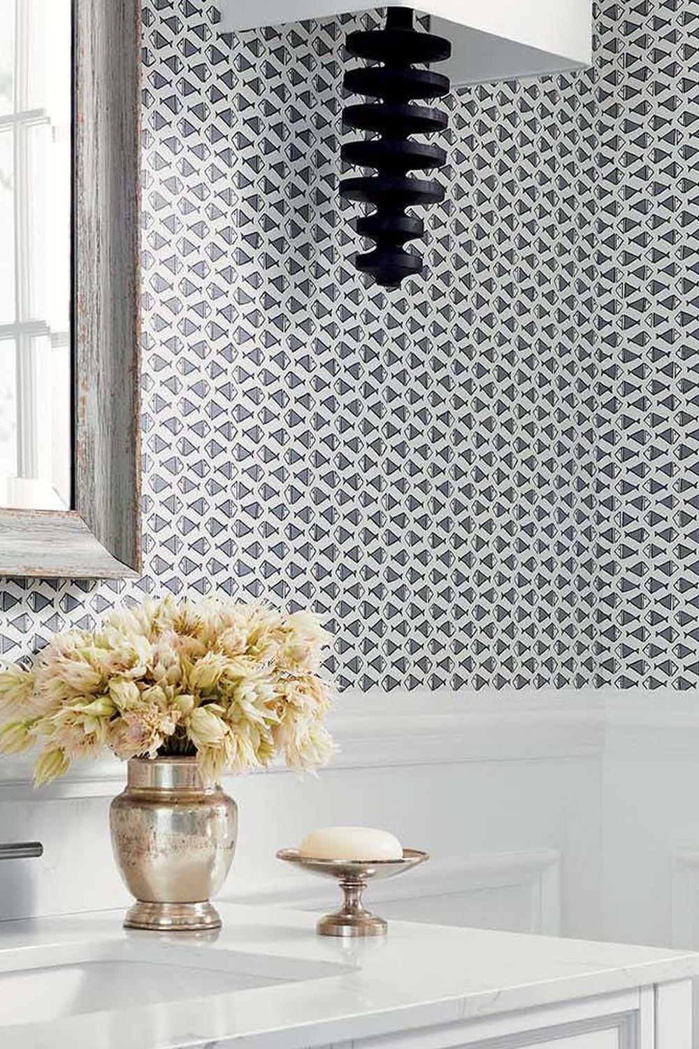 Stylish bathroom featuring Thibaut geometric wallpaper with vibrant blue and white patterns