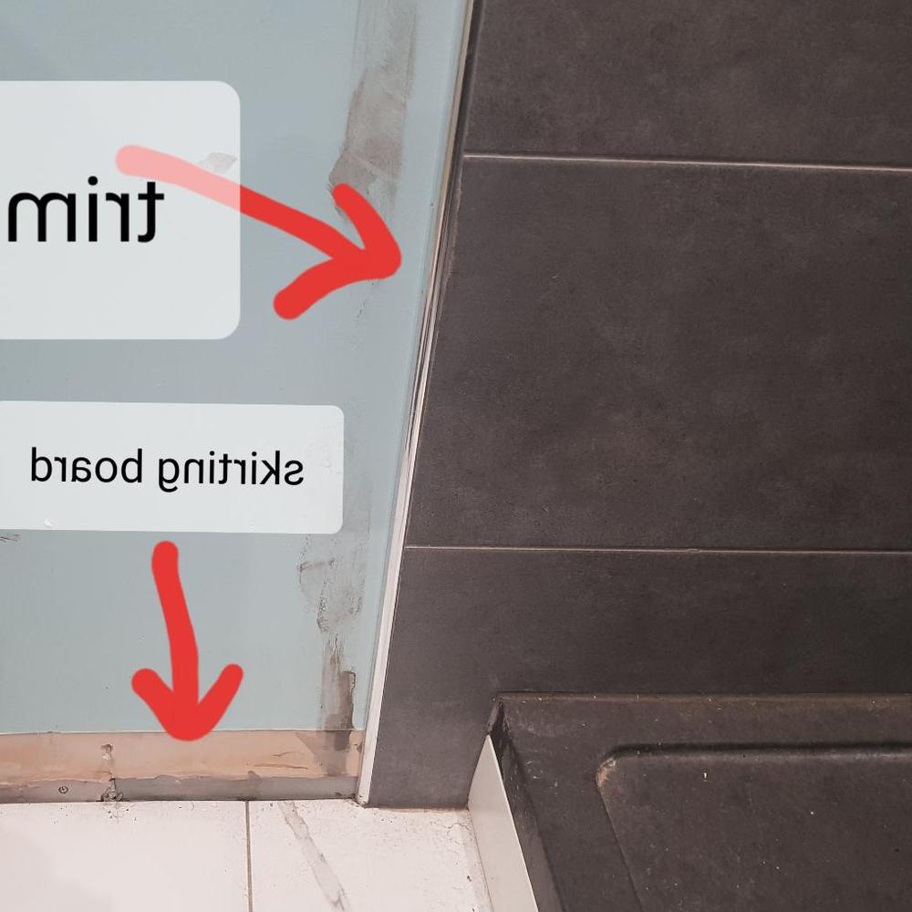 Bathroom showcasing a transition between darker and lighter tiles.