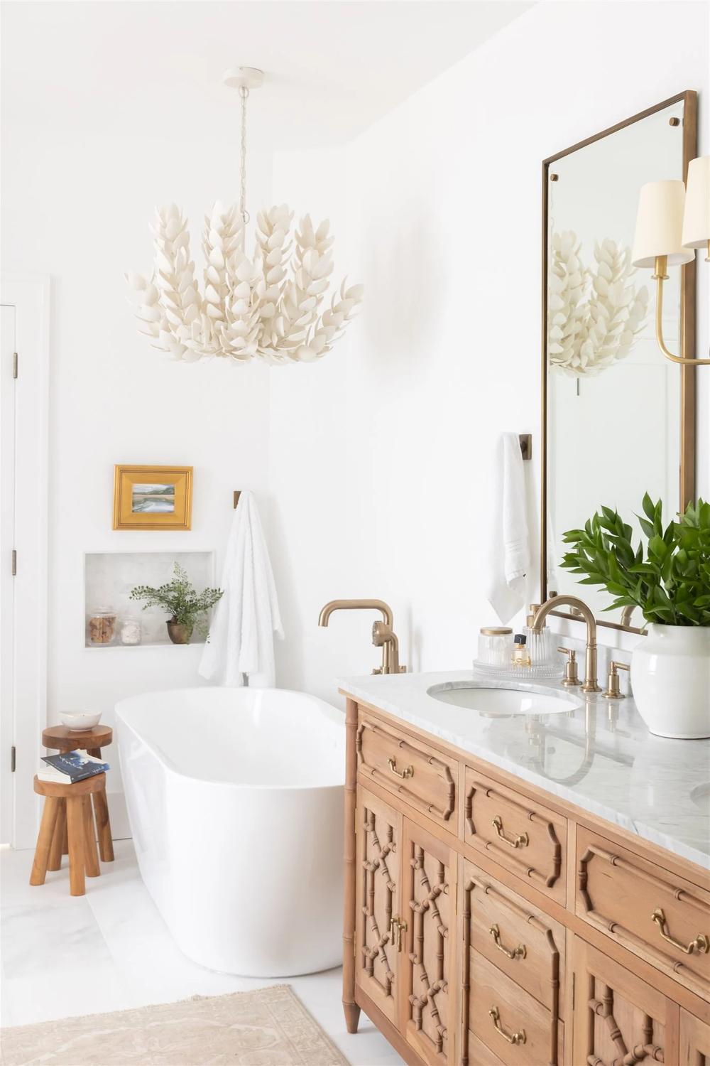 Elegant bathroom showcasing wood tones, a freestanding tub, and intricate molding for a classic timeless appeal.
