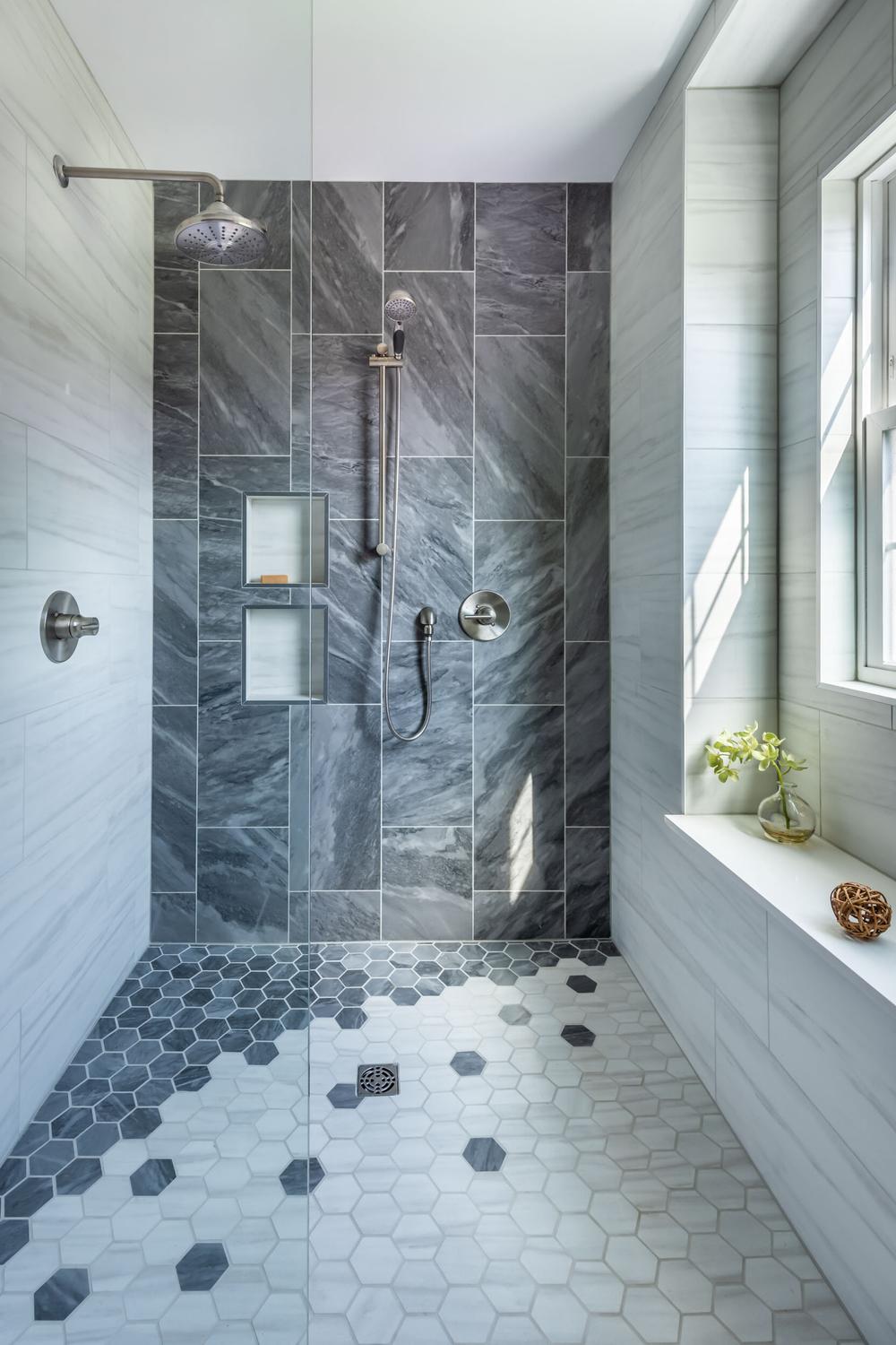 Ducha moderna con paneles de vidrio y azulejos de mármol gris
