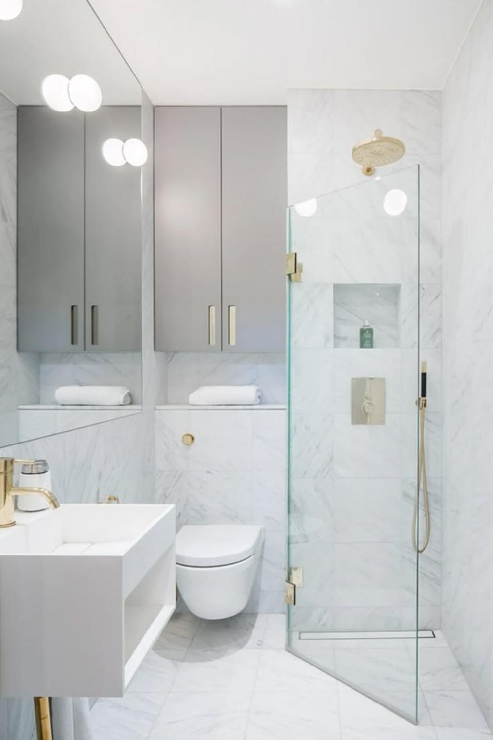 Baño con ducha espaciosa y azulejos de mármol