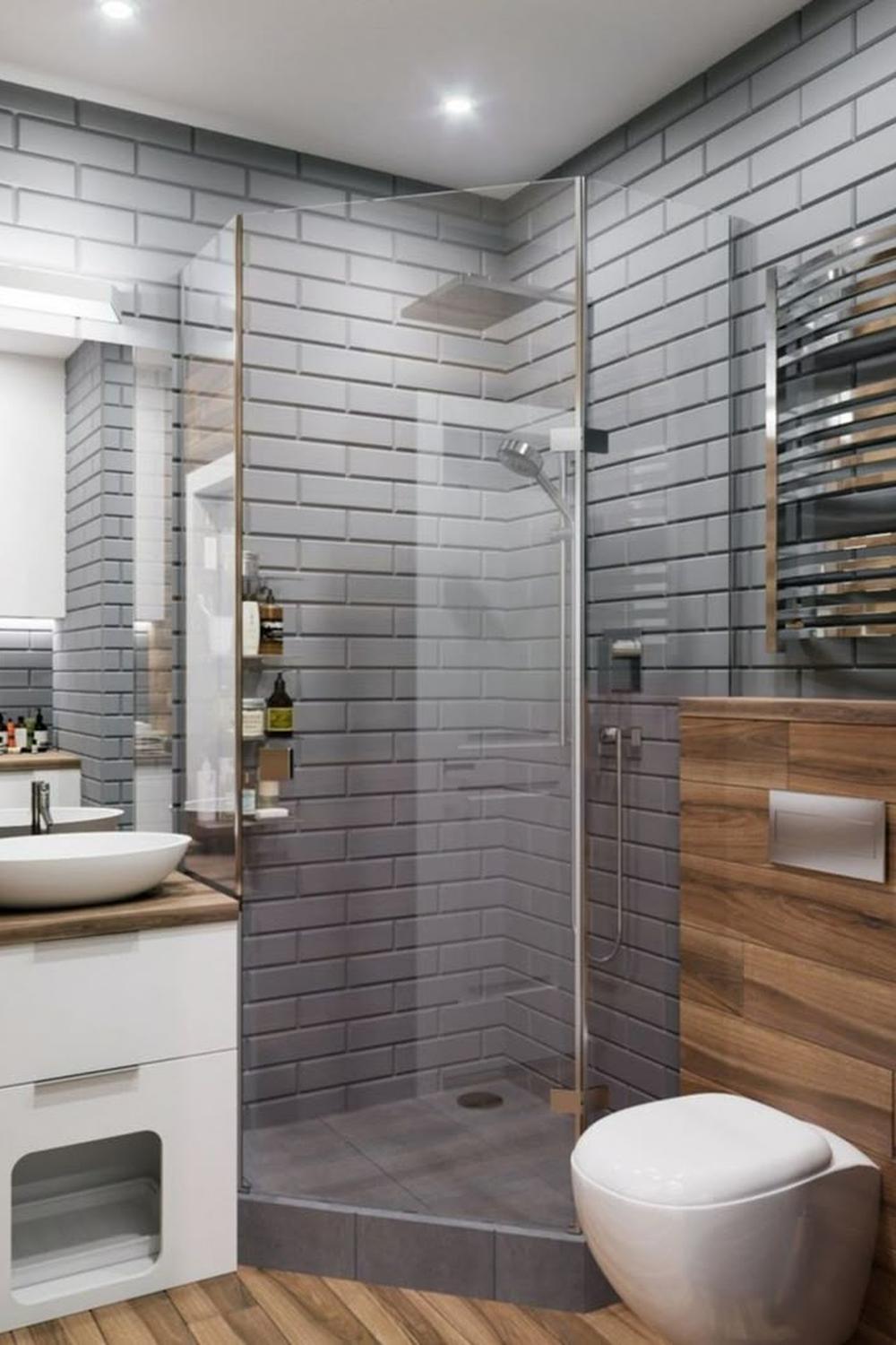 Baño compacto con azulejos grises y detalles en madera