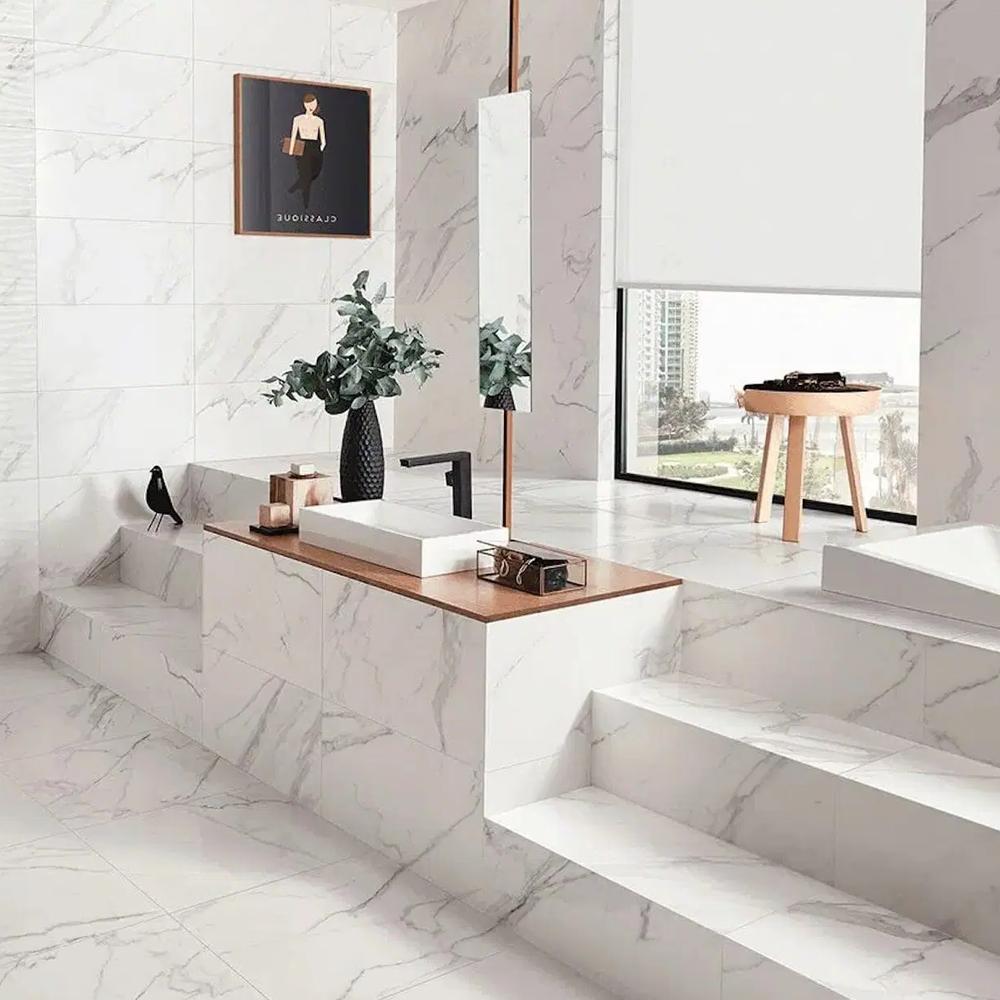 Modern bathroom designed with large marble-effect tiles for an elegant luxury.
