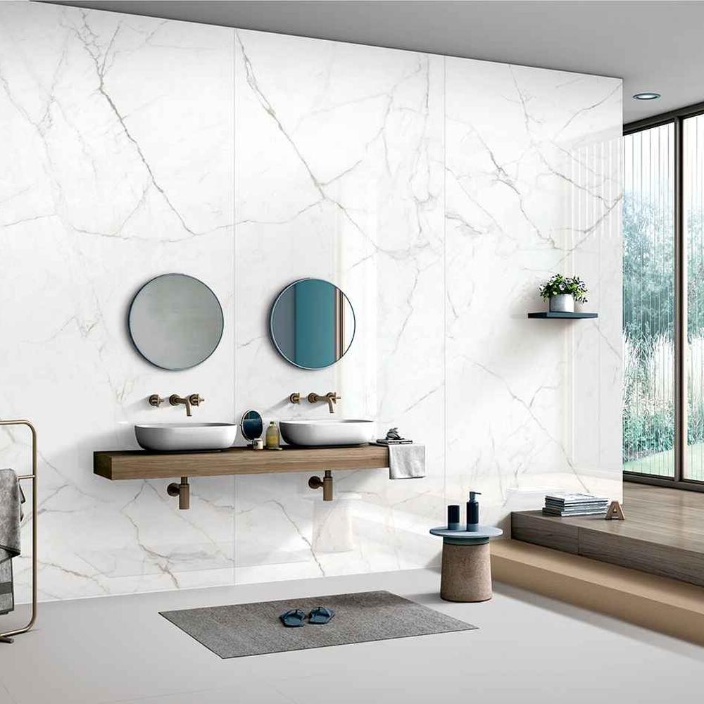 Luxurious bathroom featuring minimalist white and gold veined tiles.