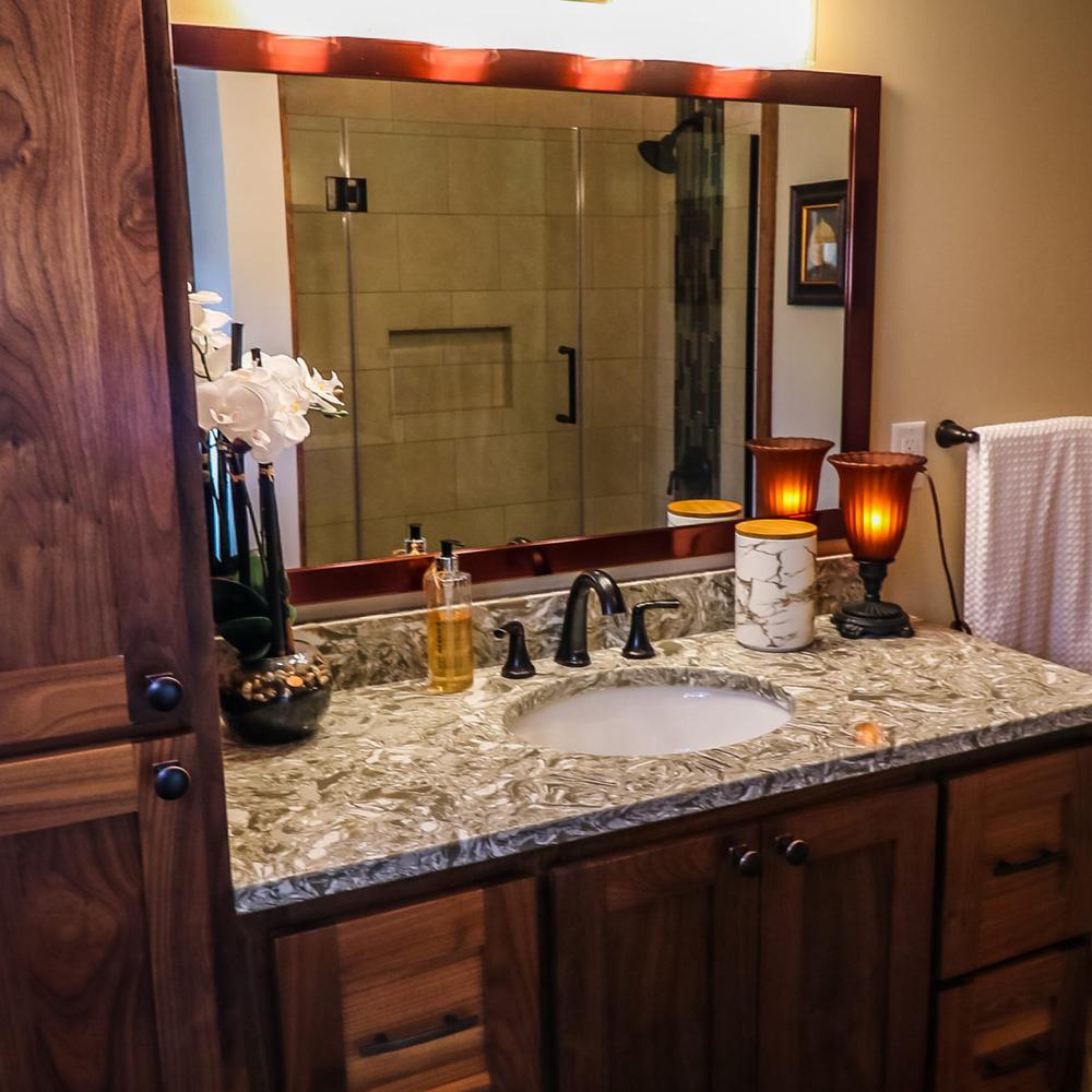 Elegant Tuscan bathroom featuring a vanity and decorative touches