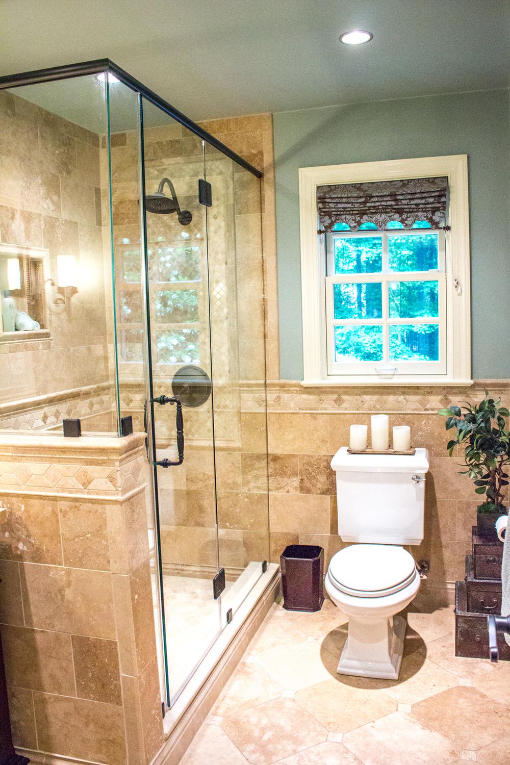 Warm Tuscan bathroom with classic details and luxurious textures