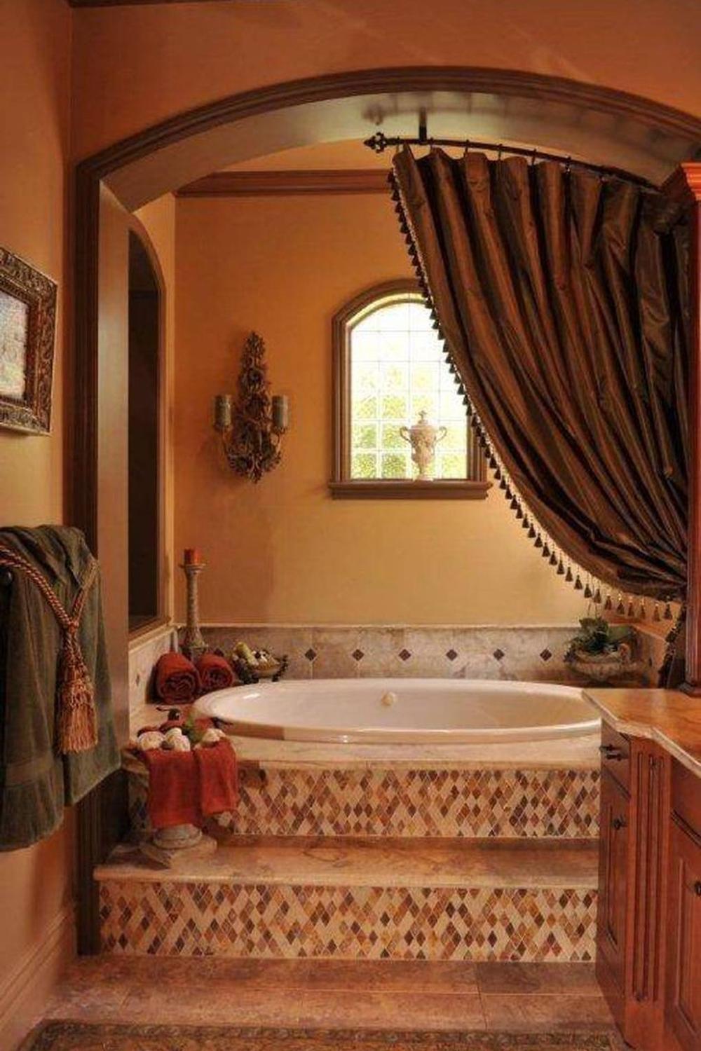 Luxurious bathroom with an elevated oval-shaped bathtub on a mosaic platform.