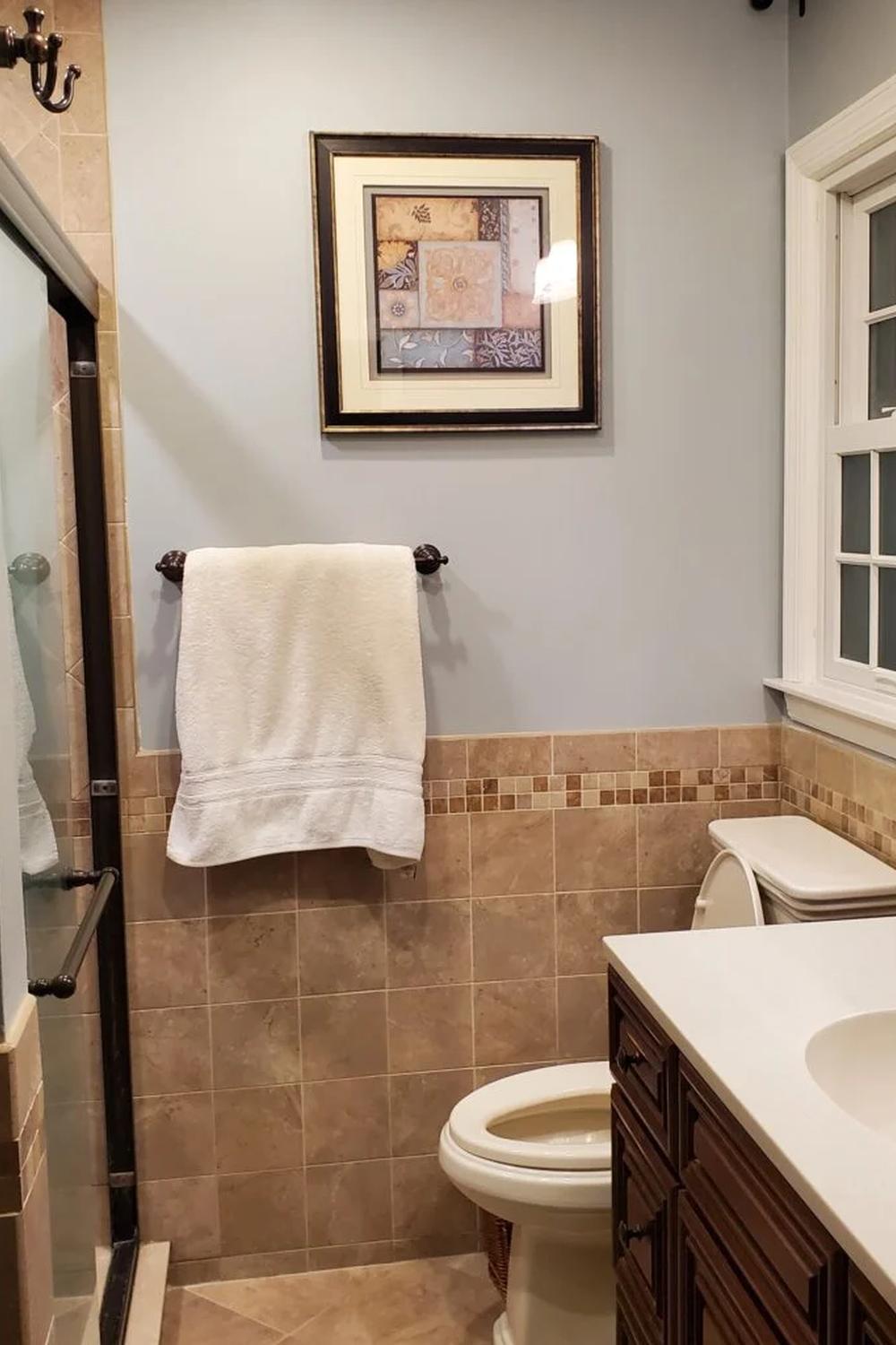 Beautiful Tuscan bathroom with muted blue tones and natural textures.