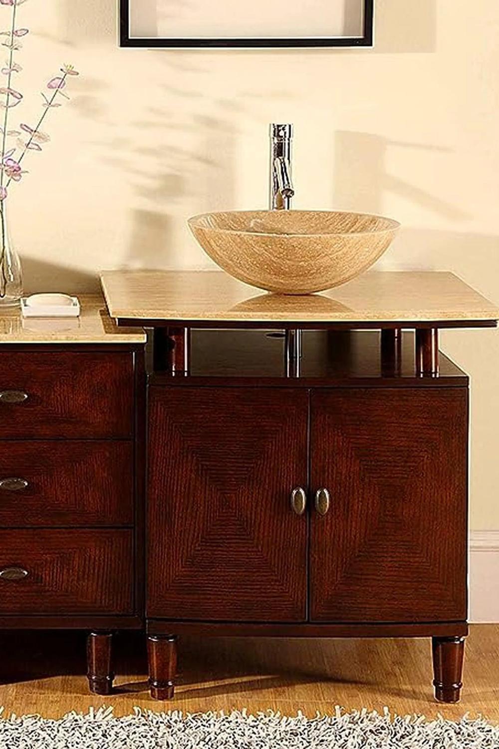 Warm brown stone vessel sink with modern brushed gold faucet