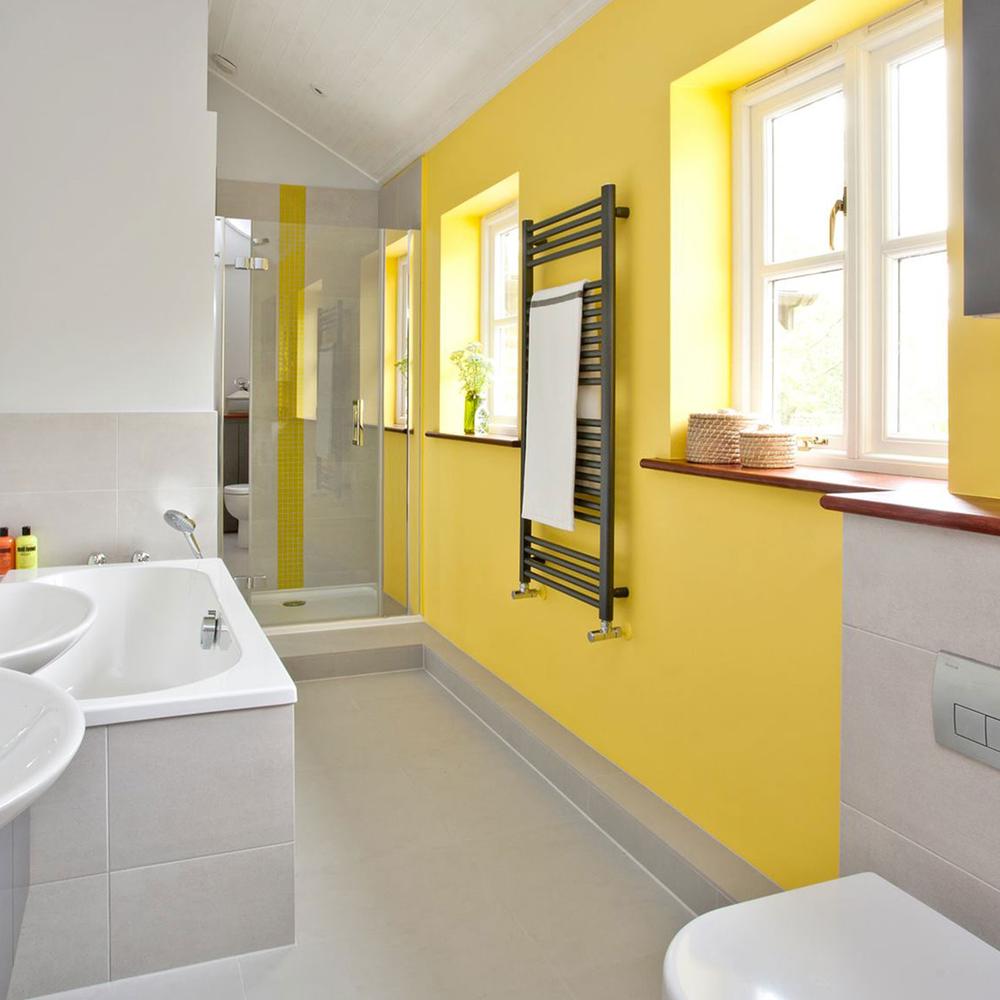 A vibrant bathroom featuring cheerful yellow walls and modern fixtures