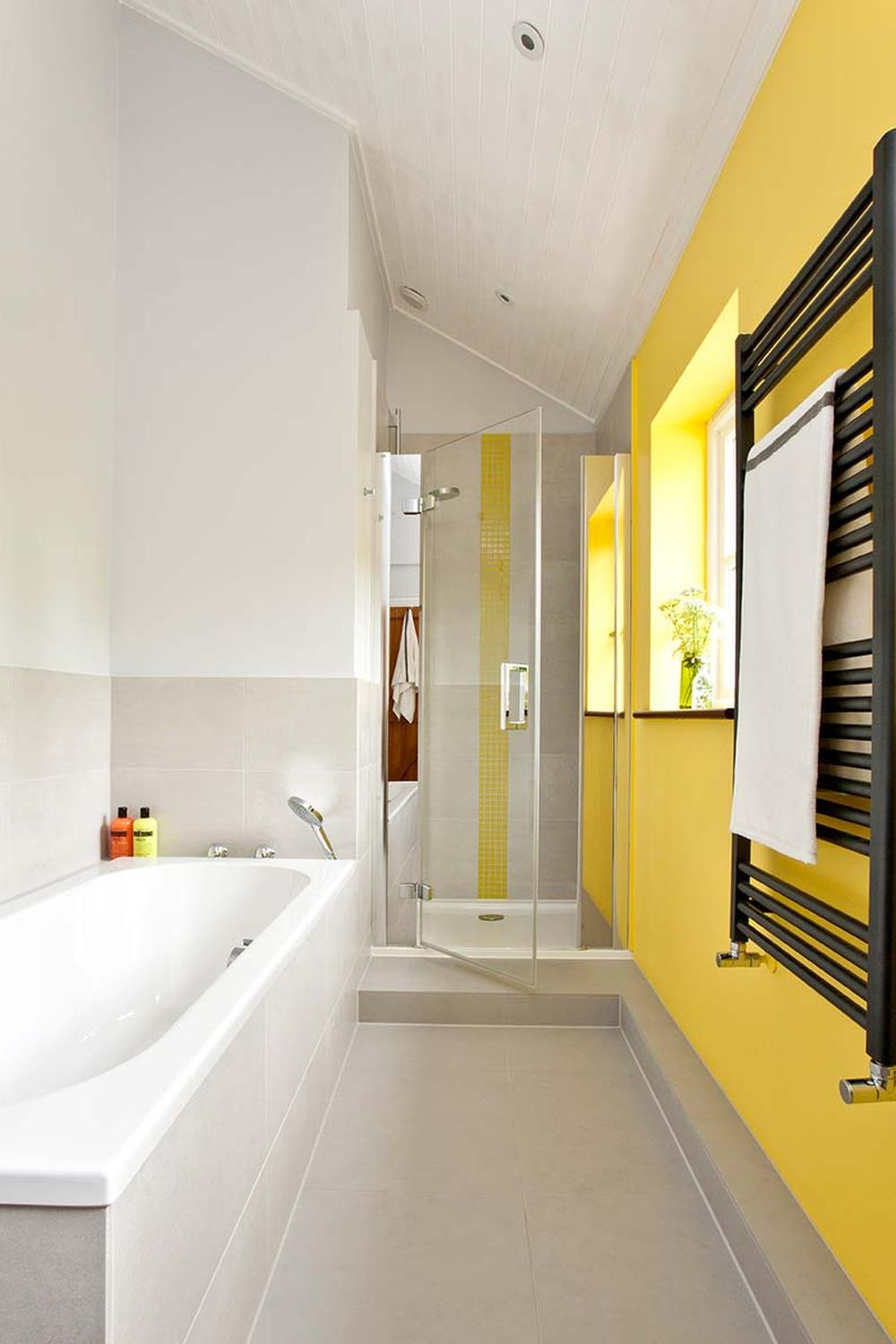 A modern bathroom with bright gray and yellow elements