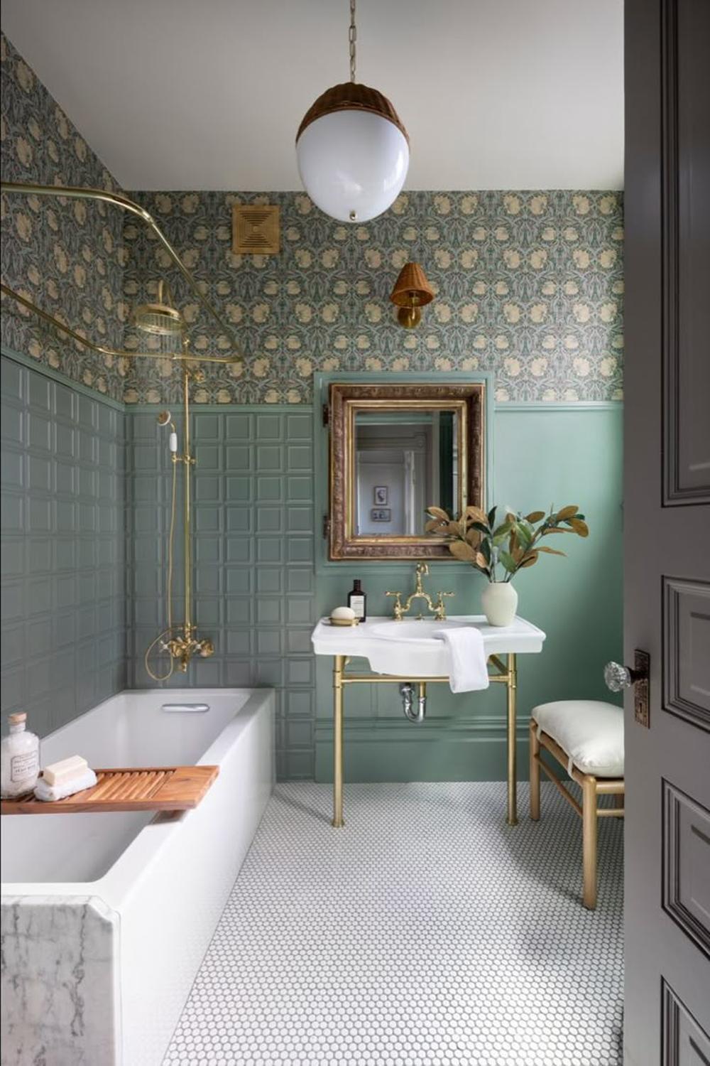 A Victorian-style bathroom with soft green walls and floral wallpaper.